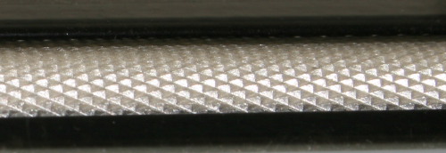 Knurled metal feed roller
